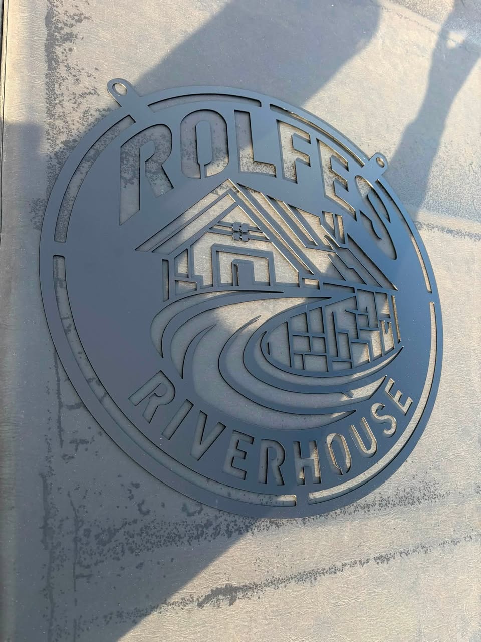 Round steel property sign with river house design