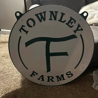 Round farm sign finished in white and green