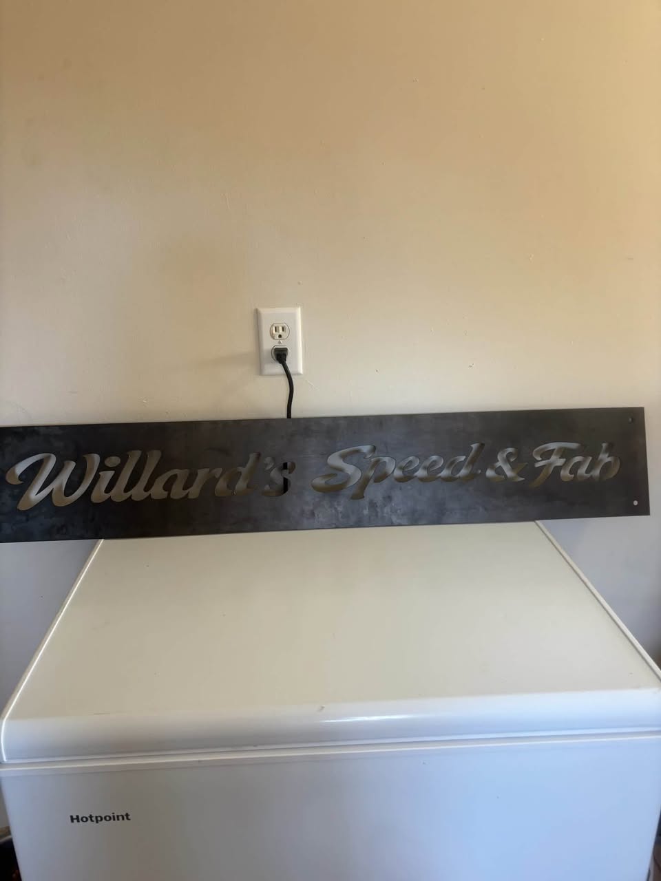 Script-lettered steel shop sign